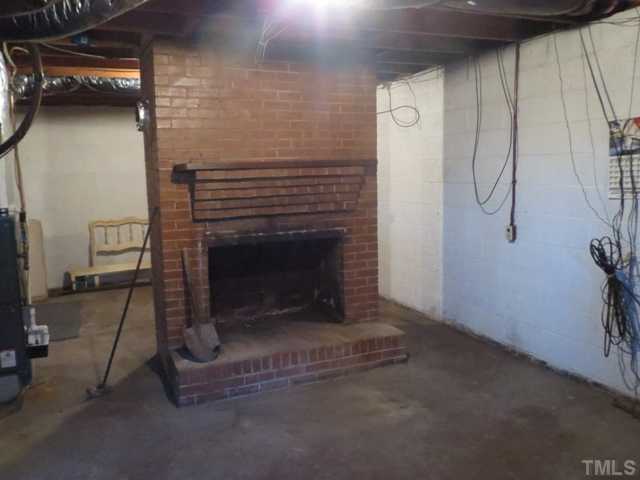 929 Old Allensville Road Roxboro, NC 27574 - Photo 4 of 6 a living room with a fireplace
