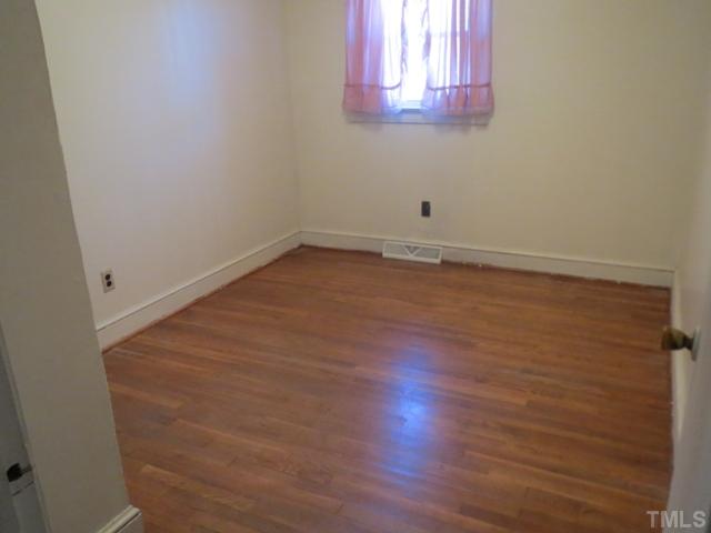 929 Old Allensville Road Roxboro, NC 27574 - Photo 5 of 6 a view of a room that has wooden floor and cabinets