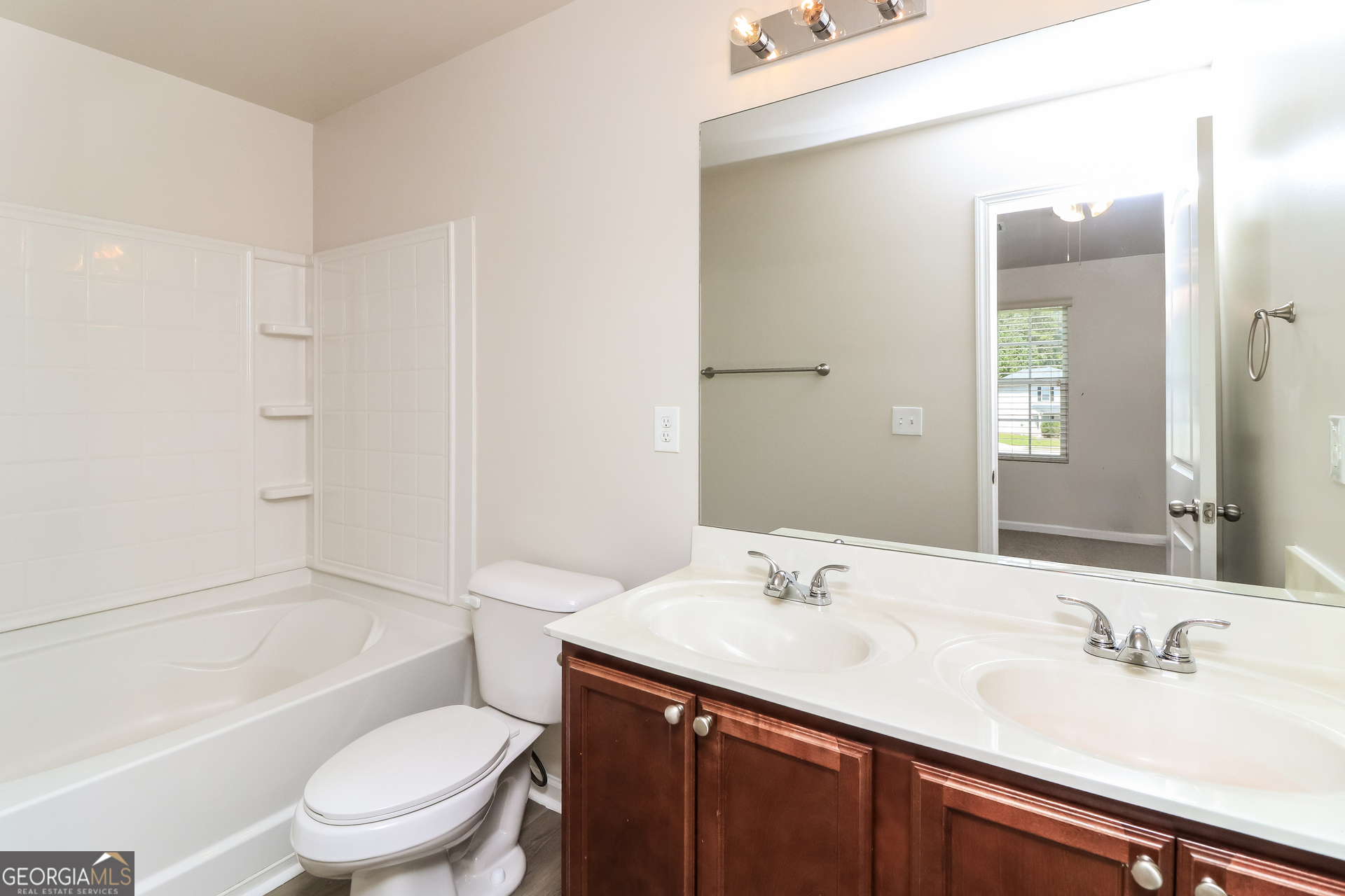 404 Scenic View Court Villa Rica, GA 30180 - Photo 12 of 17 a bathroom with a sink a toilet and shower