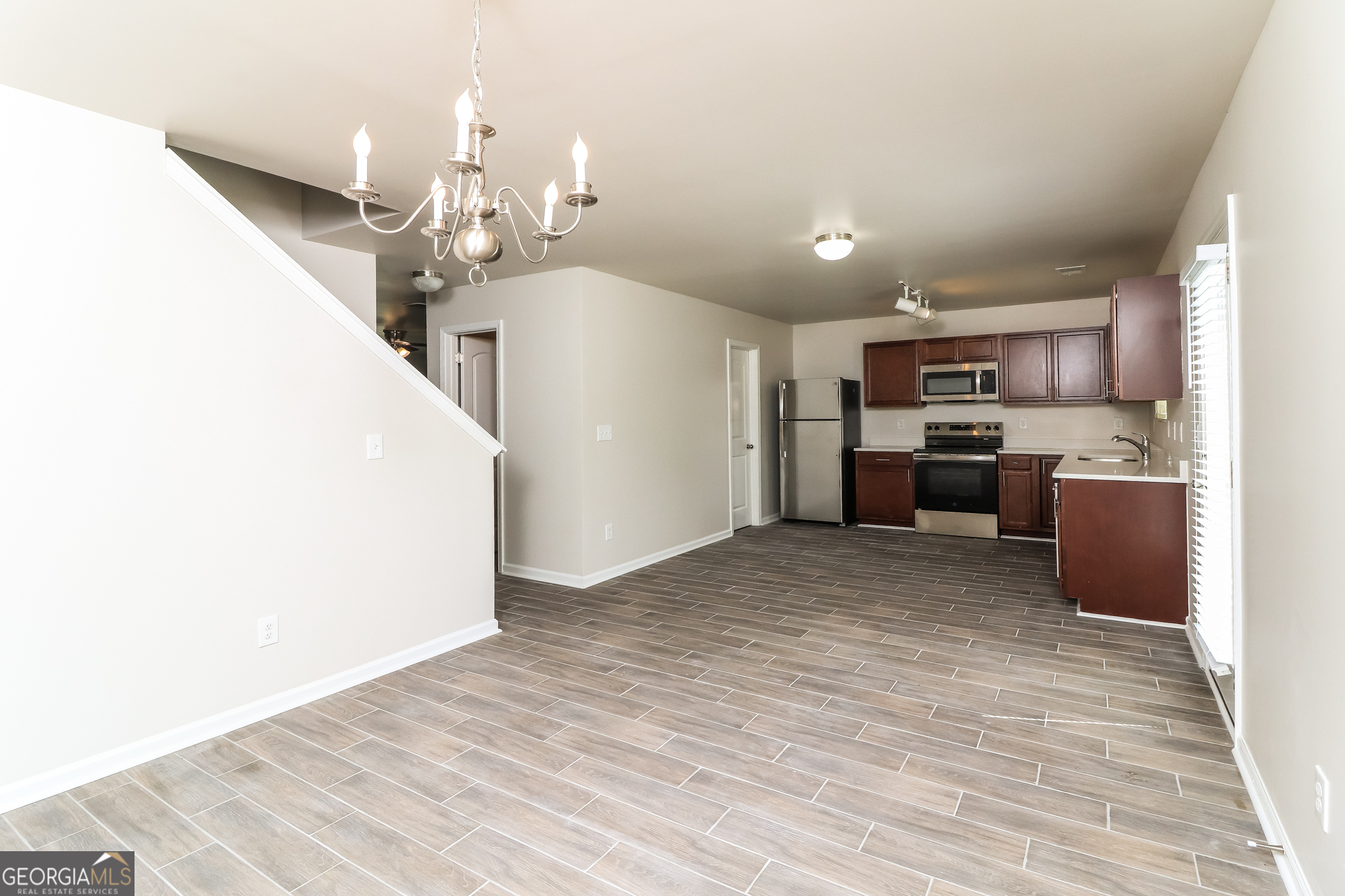 404 Scenic View Court Villa Rica, GA 30180 - Photo 3 of 17 a view of a kitchen with kitchen island wooden floor center island and stainless steel appliances