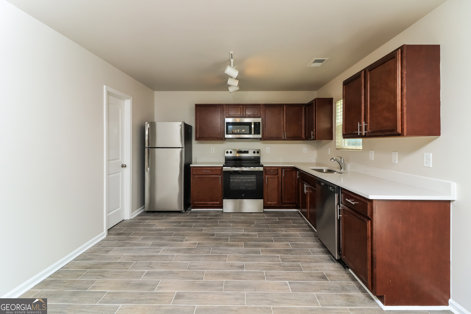 404 Scenic View Court Villa Rica, GA 30180 - Photo 8 of 17 a kitchen with granite countertop a refrigerator and a stove top oven