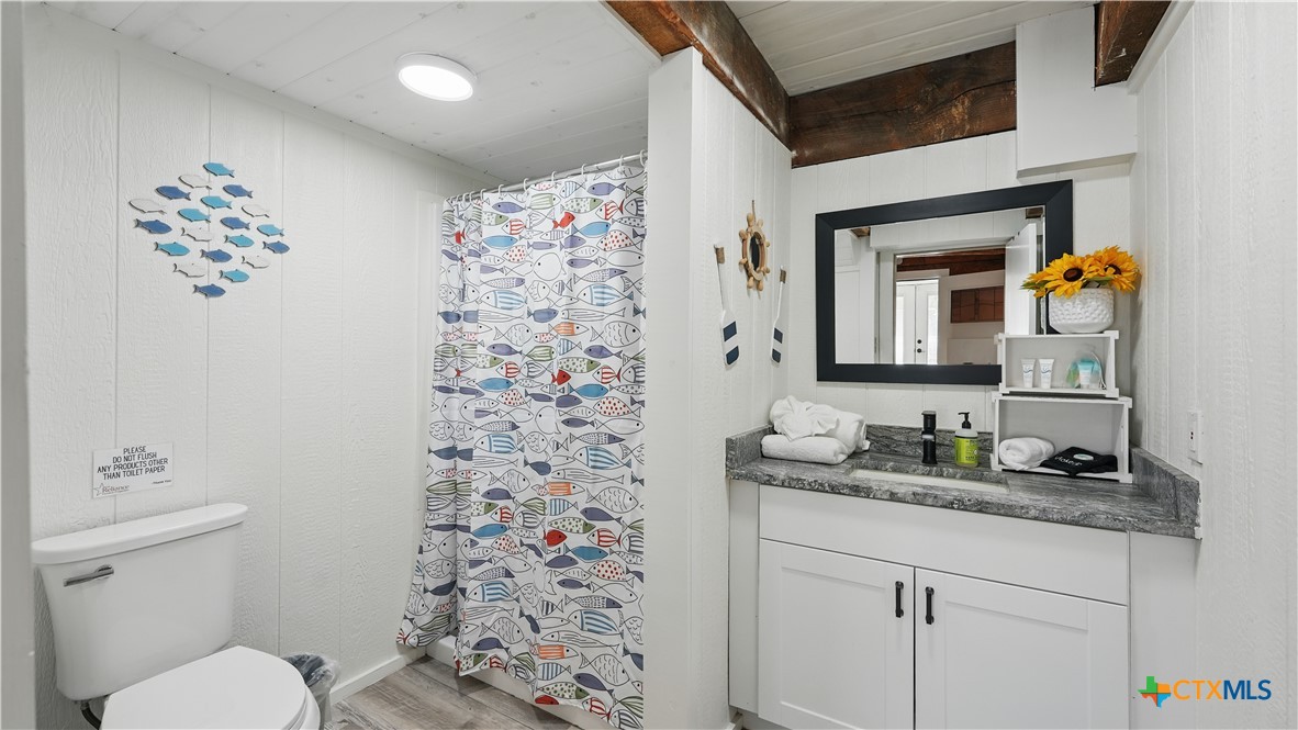 205 Bravo Road Canyon Lake, TX 78133 - Photo 11 of 38 a bathroom with a sink toilet and shower