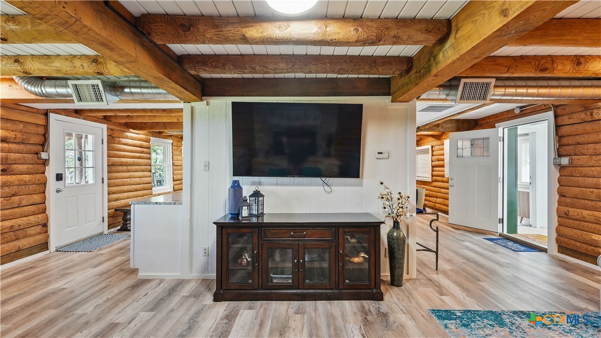 205 Bravo Road Canyon Lake, TX 78133 - Photo 13 of 38 a living room with a table and a flat screen tv