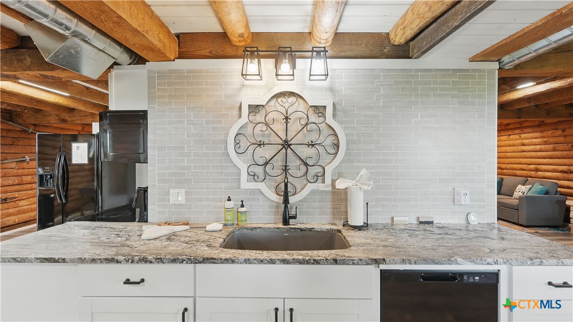 205 Bravo Road Canyon Lake, TX 78133 - Photo 14 of 38 a bathroom with a granite countertop sink and a mirror