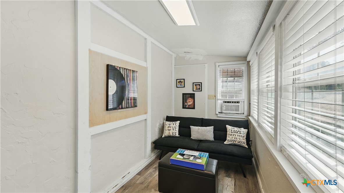 205 Bravo Road Canyon Lake, TX 78133 - Photo 16 of 38 a living room with furniture and a floor to ceiling window