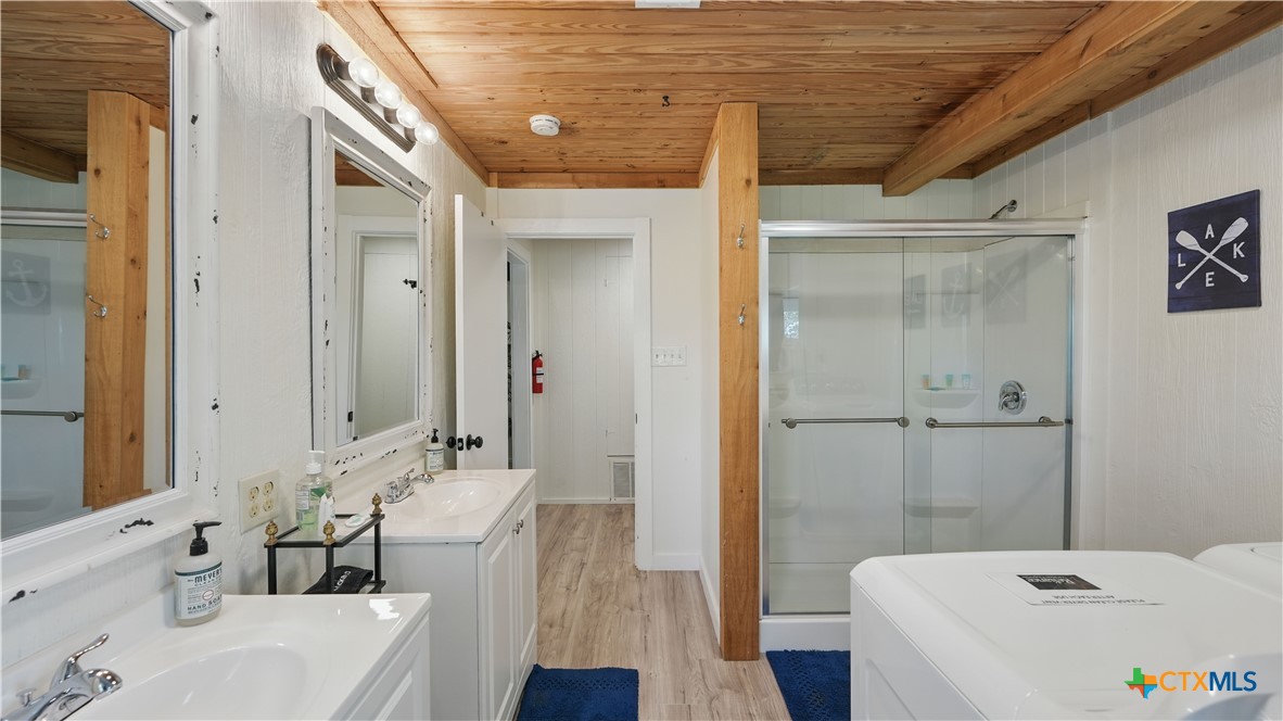 205 Bravo Road Canyon Lake, TX 78133 - Photo 20 of 38 a bathroom with a tub sink and mirror