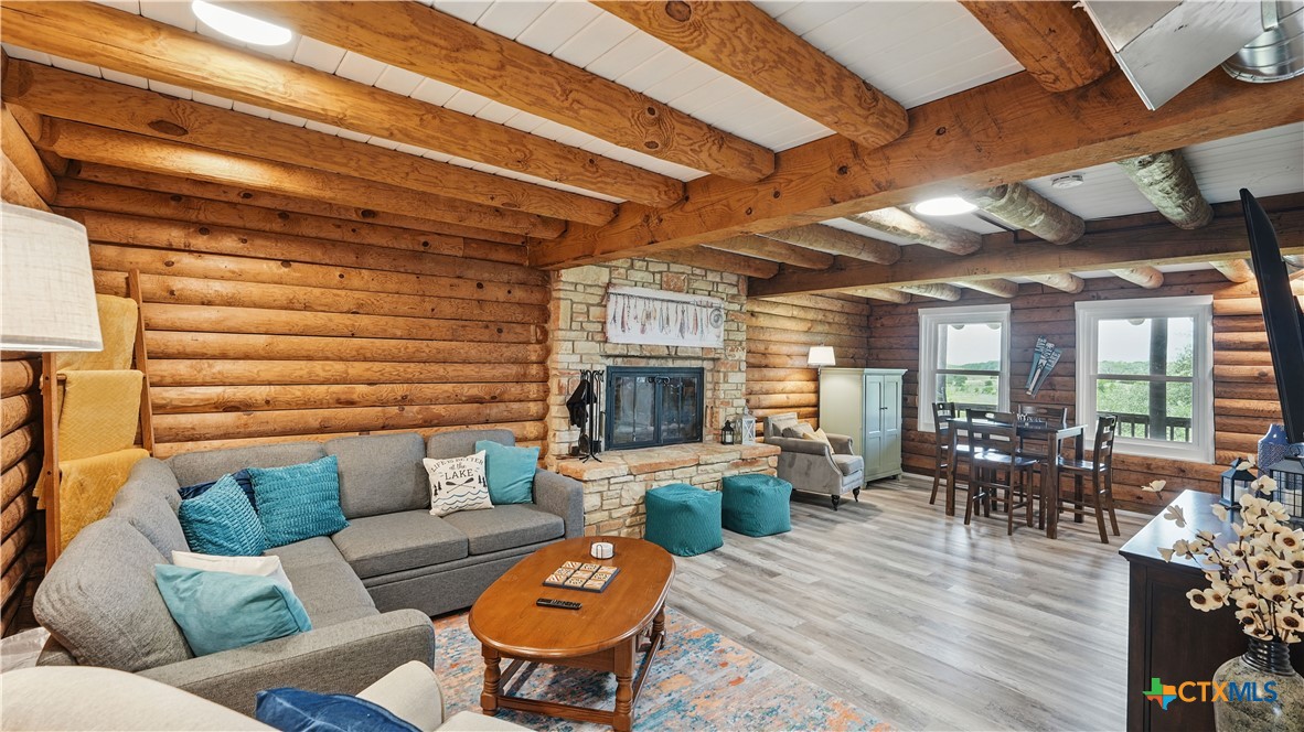 205 Bravo Road Canyon Lake, TX 78133 - Photo 2 of 38 a living room with furniture wooden floor and outdoor view