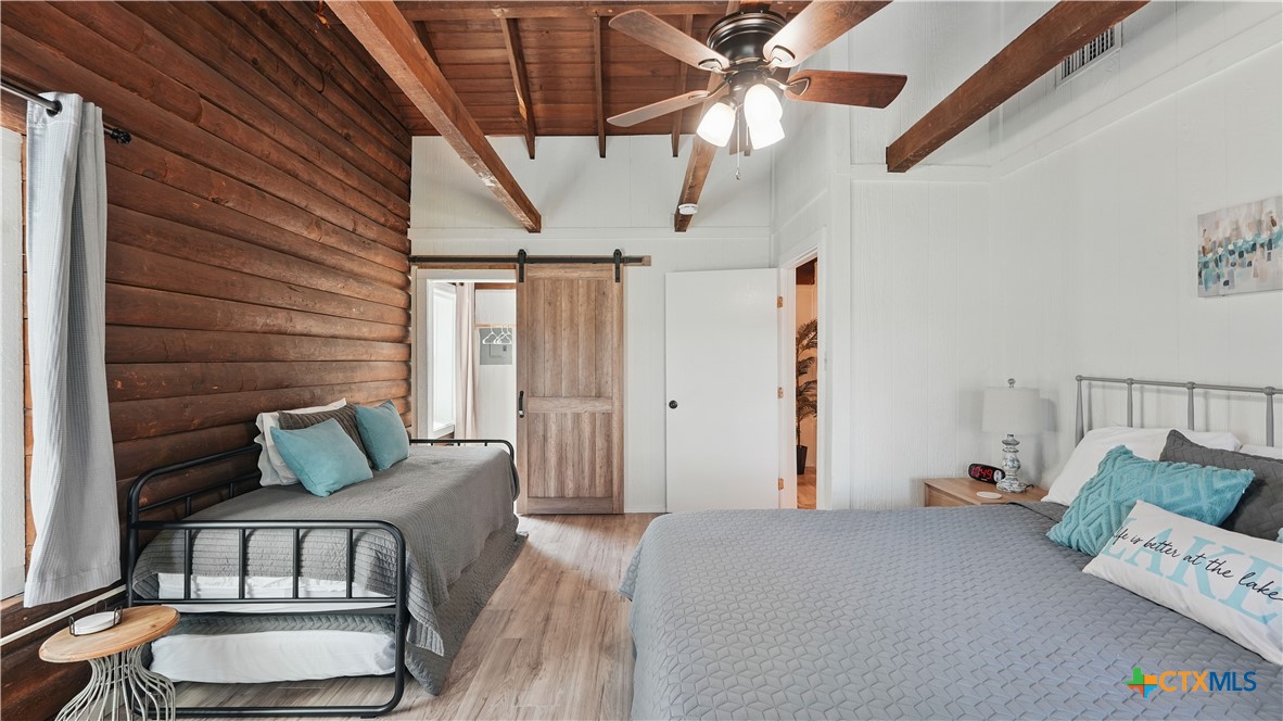 205 Bravo Road Canyon Lake, TX 78133 - Photo 24 of 38 a bedroom with furniture and wooden floor