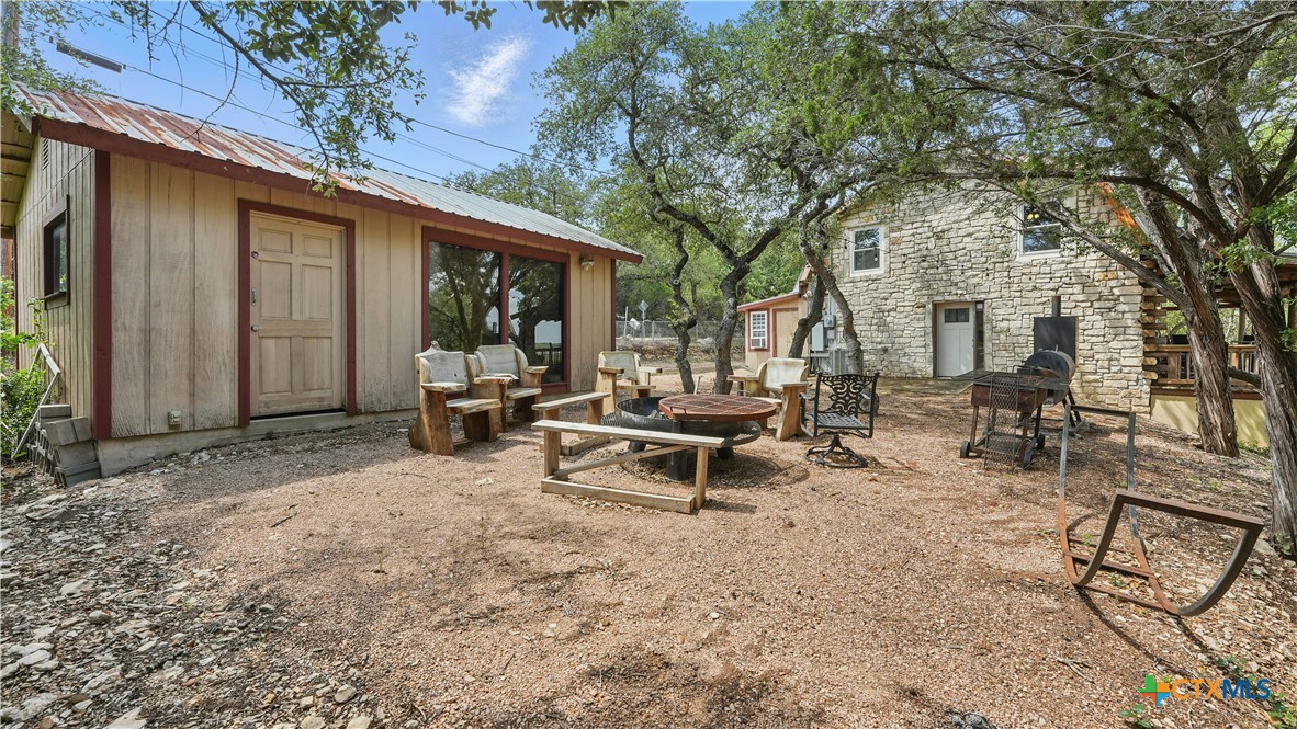 205 Bravo Road Canyon Lake, TX 78133 - Photo 27 of 38 a view of a house with backyard sitting area and garden