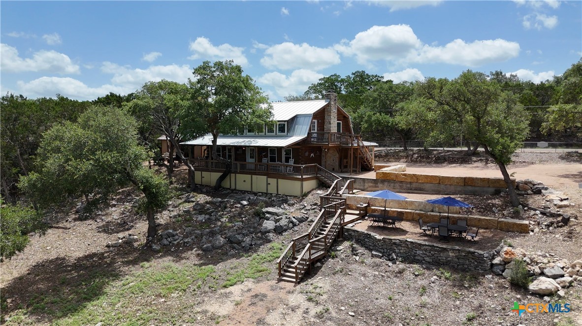 205 Bravo Road Canyon Lake, TX 78133 - Photo 29 of 38 a view of a backyard with sitting area