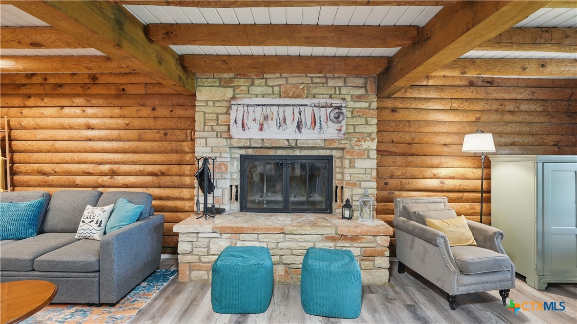 205 Bravo Road Canyon Lake, TX 78133 - Photo 3 of 38 a living room with furniture and a fireplace