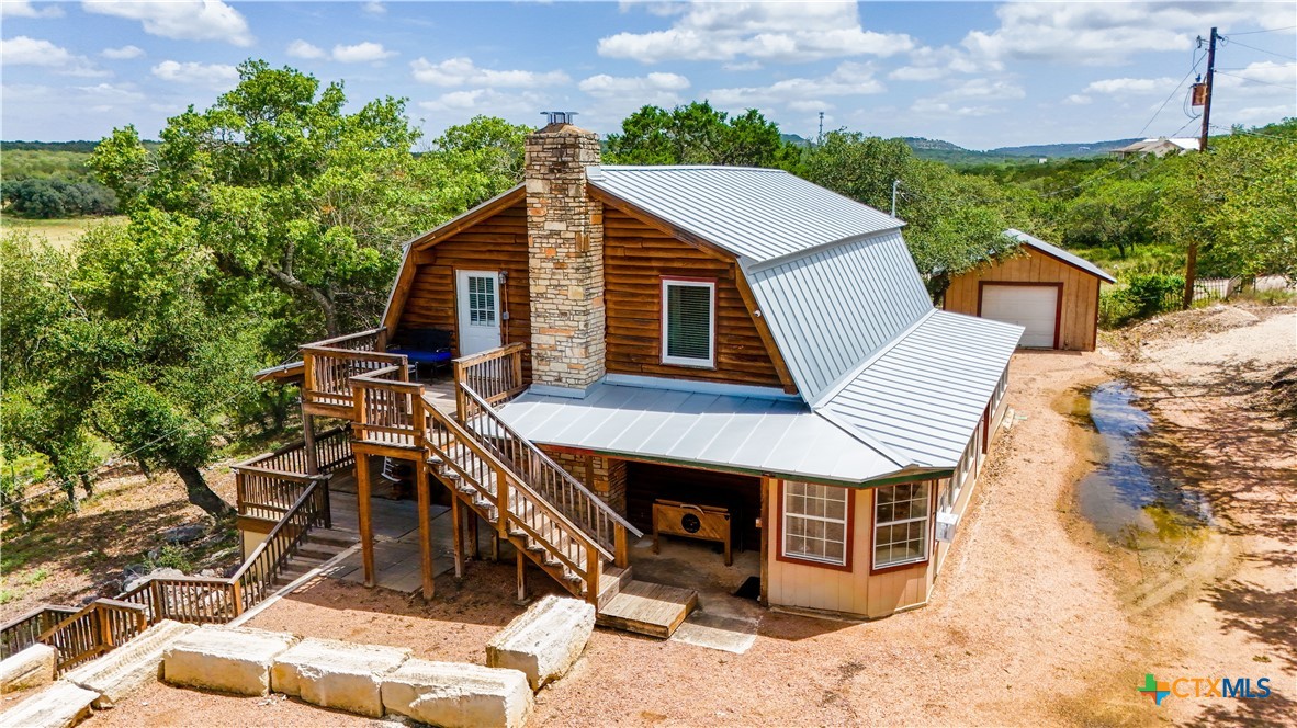 205 Bravo Road Canyon Lake, TX 78133 - Photo 34 of 38 a view of a house with a yard