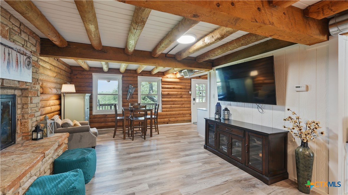 205 Bravo Road Canyon Lake, TX 78133 - Photo 4 of 38 a living room with furniture a flat screen tv and wooden floor