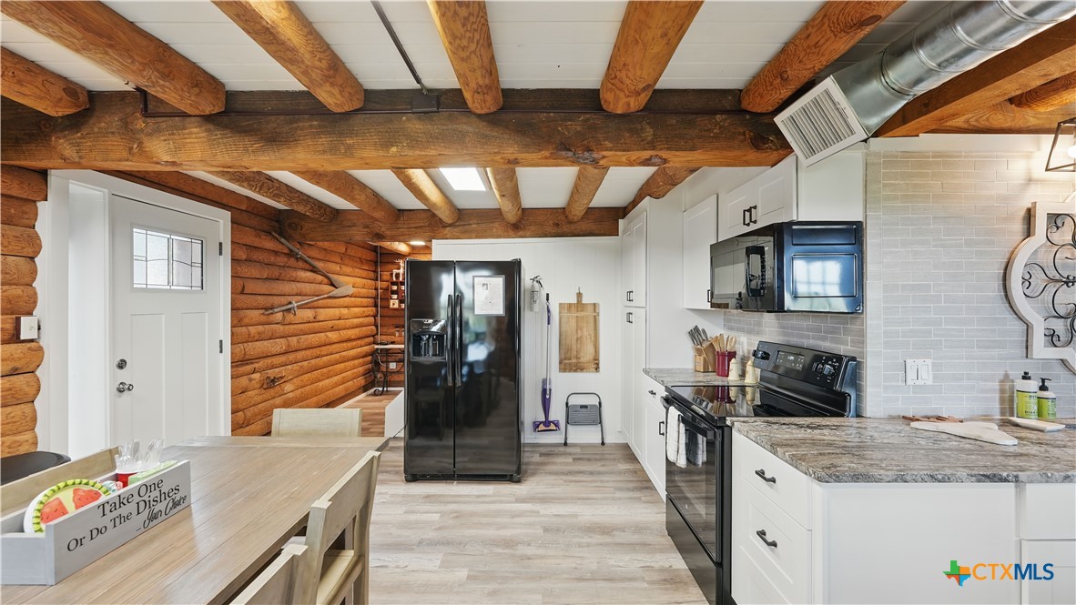 205 Bravo Road Canyon Lake, TX 78133 - Photo 7 of 38 a kitchen with granite countertop lots of counter top space and stainless steel appliances