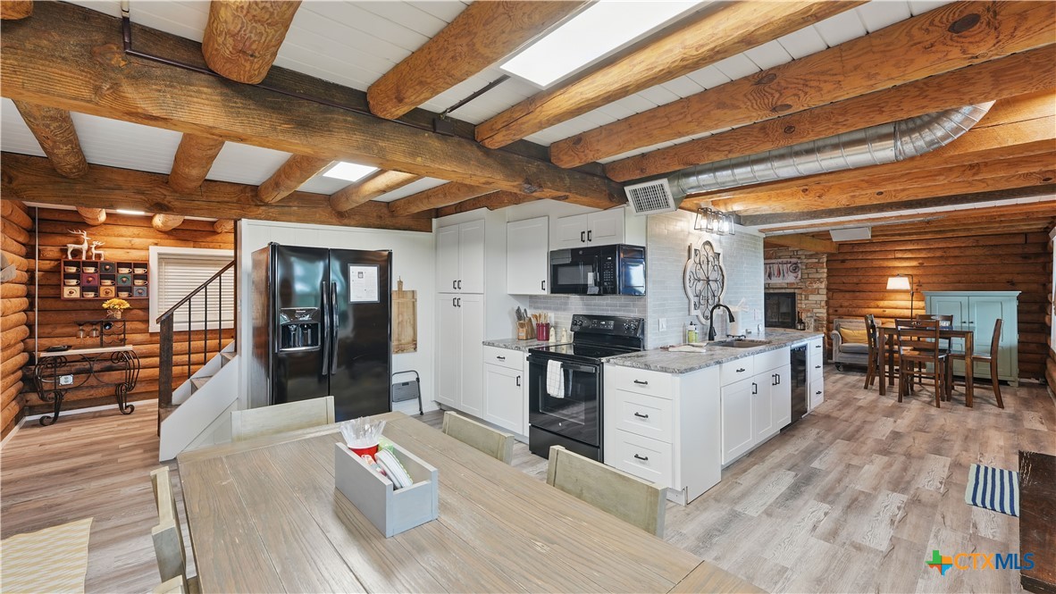 205 Bravo Road Canyon Lake, TX 78133 - Photo 8 of 38 a open kitchen with stainless steel appliances kitchen island granite countertop a refrigerator a stove and a sink with dishwasher