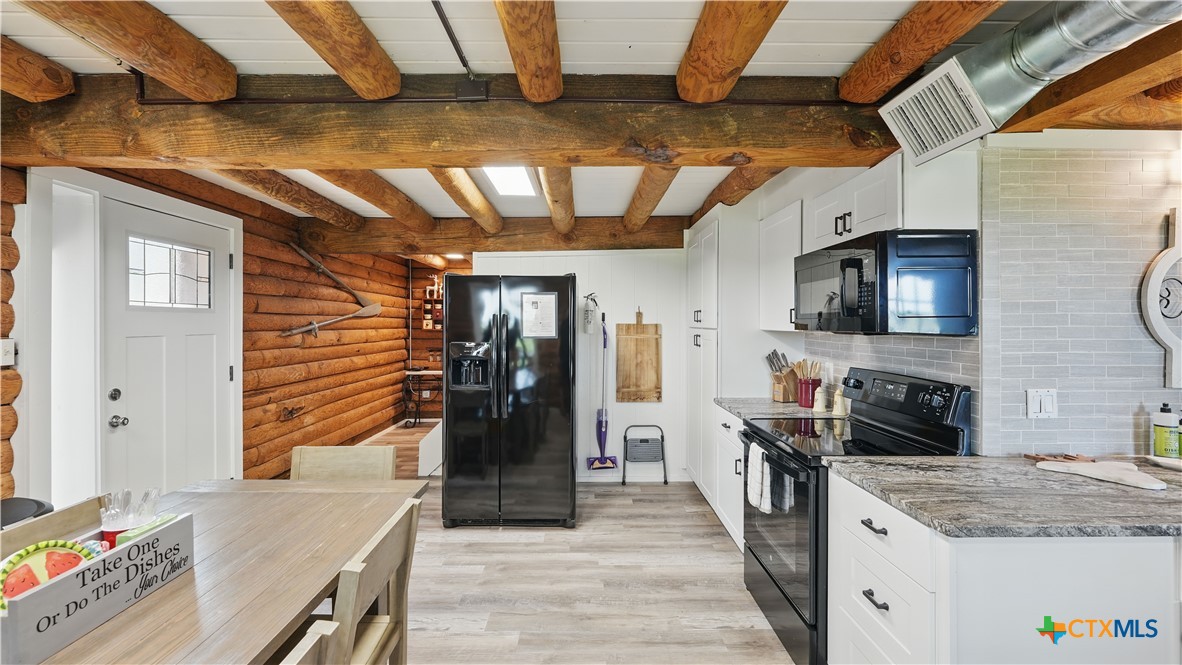 205 Bravo Road Canyon Lake, TX 78133 - Photo 9 of 38 a kitchen with stainless steel appliances granite countertop a sink stove and refrigerator