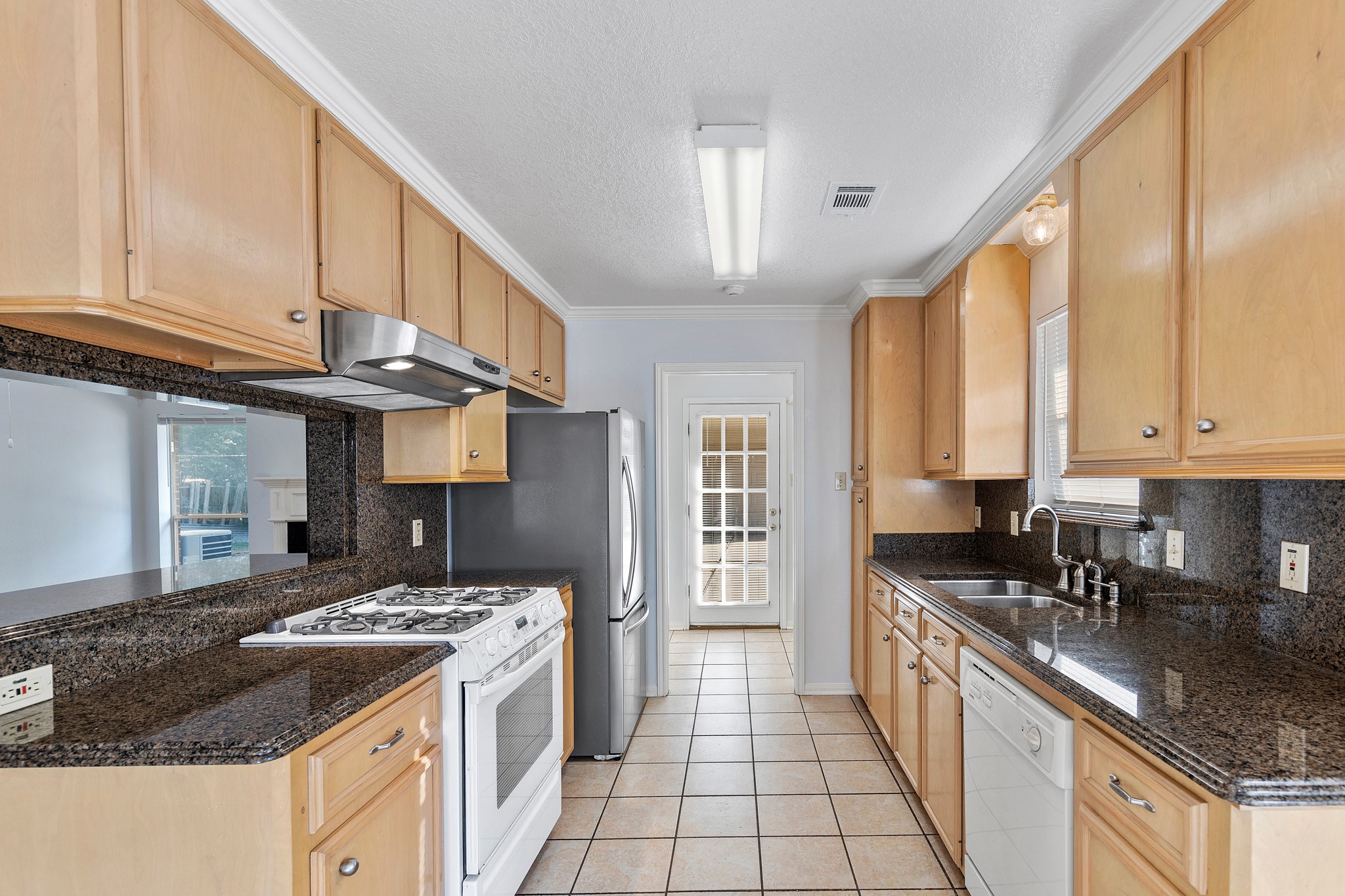 8018 Holiday Lane Houston, TX 77075 - Photo 17 of 42 a kitchen with stainless steel appliances granite countertop a stove a sink and a refrigerator