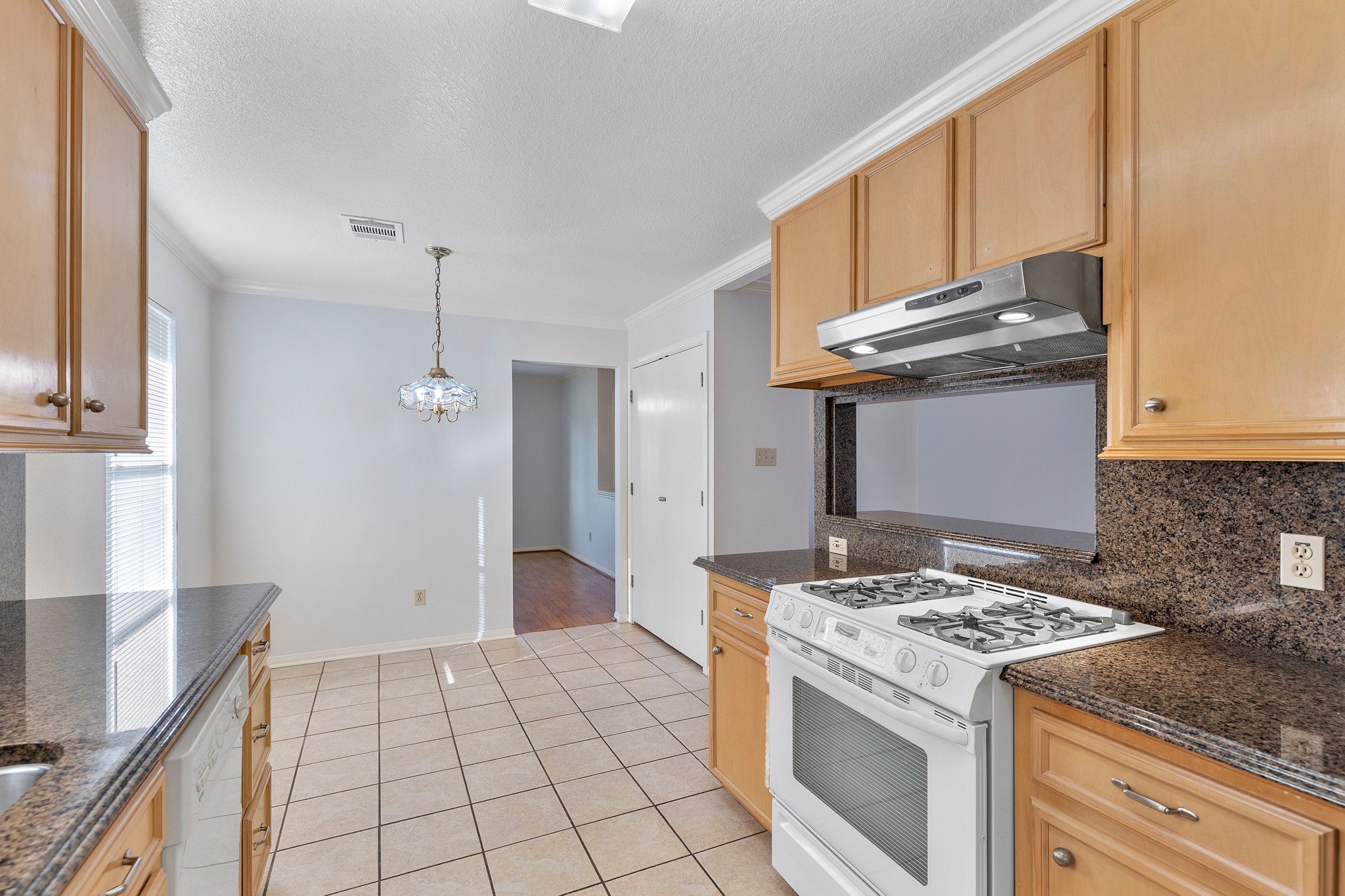 8018 Holiday Lane Houston, TX 77075 - Photo 18 of 42 a kitchen with granite countertop a stove a sink and a refrigerator