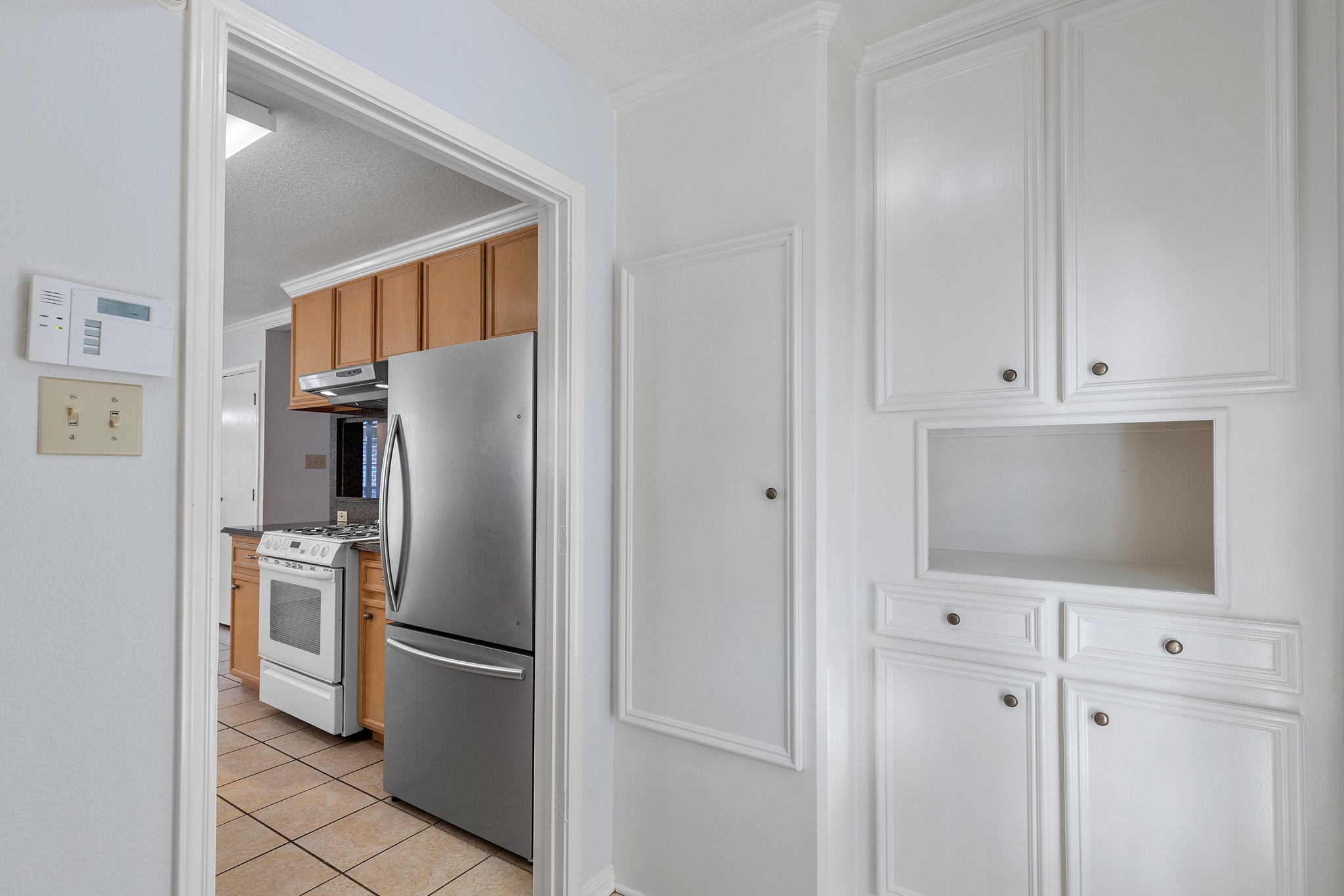 8018 Holiday Lane Houston, TX 77075 - Photo 31 of 42 a kitchen with stainless steel appliances a refrigerator a microwave and cabinets