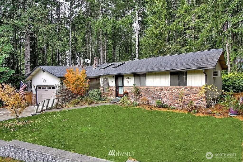 21 Boundary Road Grapeview, WA 98546 - Photo 1 of 1 a front view of a house with a garden and trees
