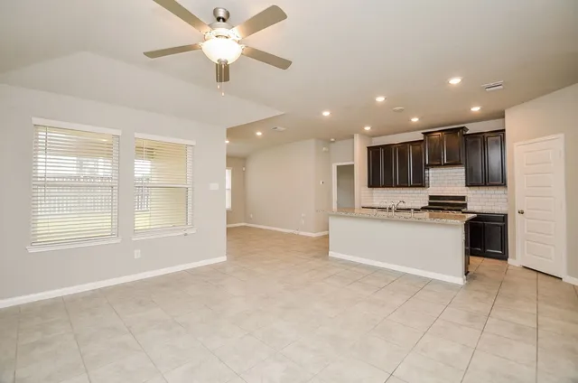 a view of kitchen with stainless steel appliances refrigerator oven and cabinets
