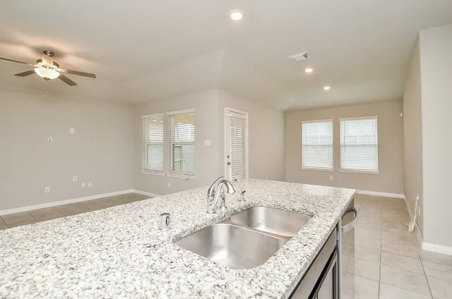 a kitchen with granite countertop a sink and a window