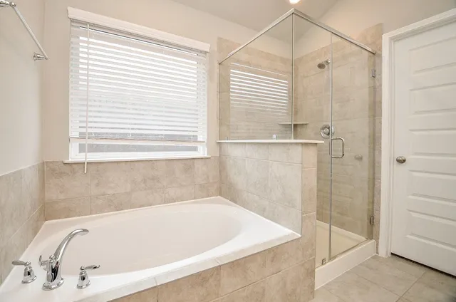 a bathroom with a tub and shower