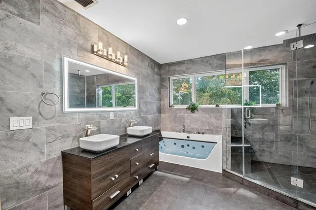 a bathroom with a double vanity sink a mirror and a shower