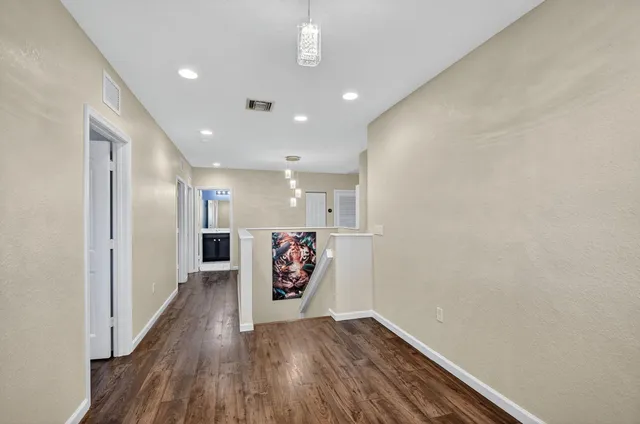 a view of a kitchen with wooden floor