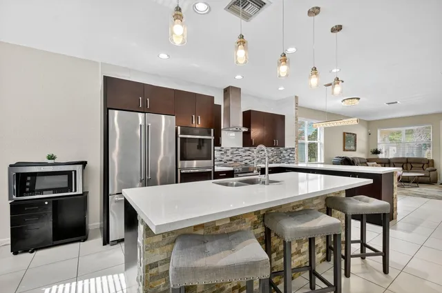 a kitchen with a table chairs microwave and refrigerator
