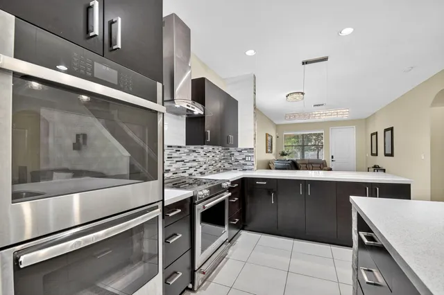a kitchen with stainless steel appliances granite countertop a sink and cabinets