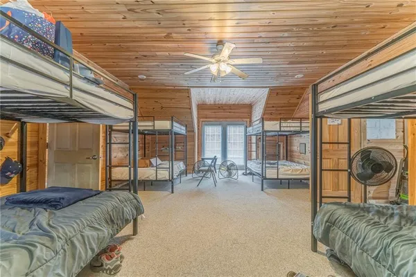 a bedroom with furniture and large windows