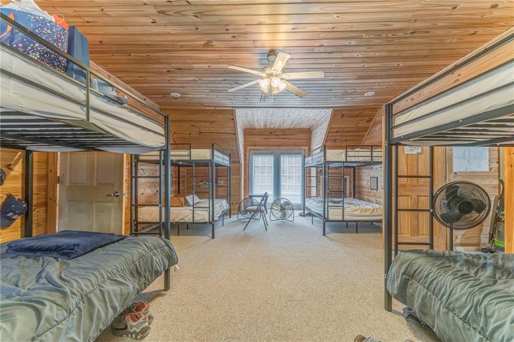 519 East Valley Road Northeast Rydal, GA 30171 - Photo 11 of 28 a bedroom with furniture and large windows