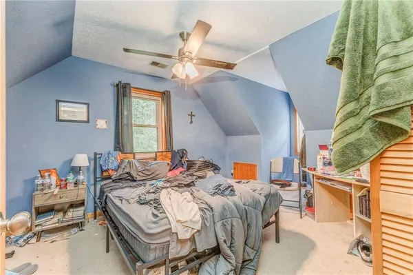 a bed room with a bed and a chair