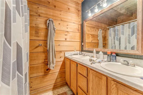 a bathroom with a granite countertop sink and a shower