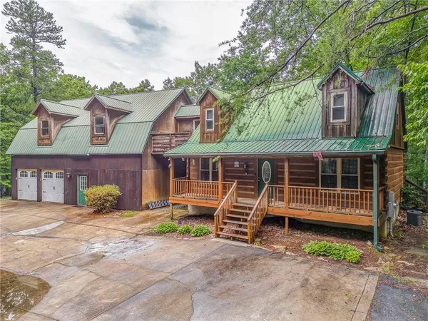 a front view of a house with a yard and a garage