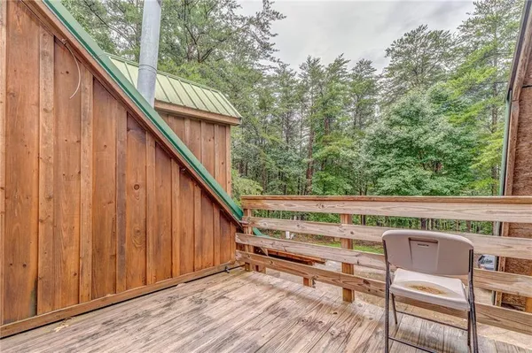 a view of balcony with wooden floor and fence