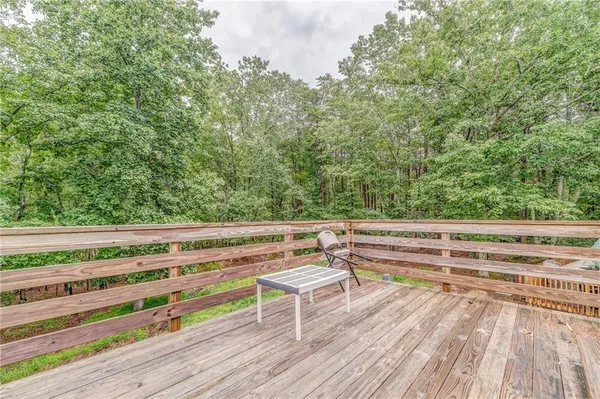 a view of backyard with deck and wooden floor