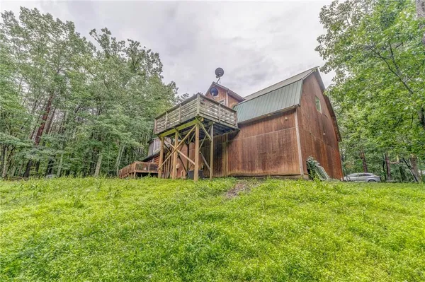 a view of a house with a yard and deck