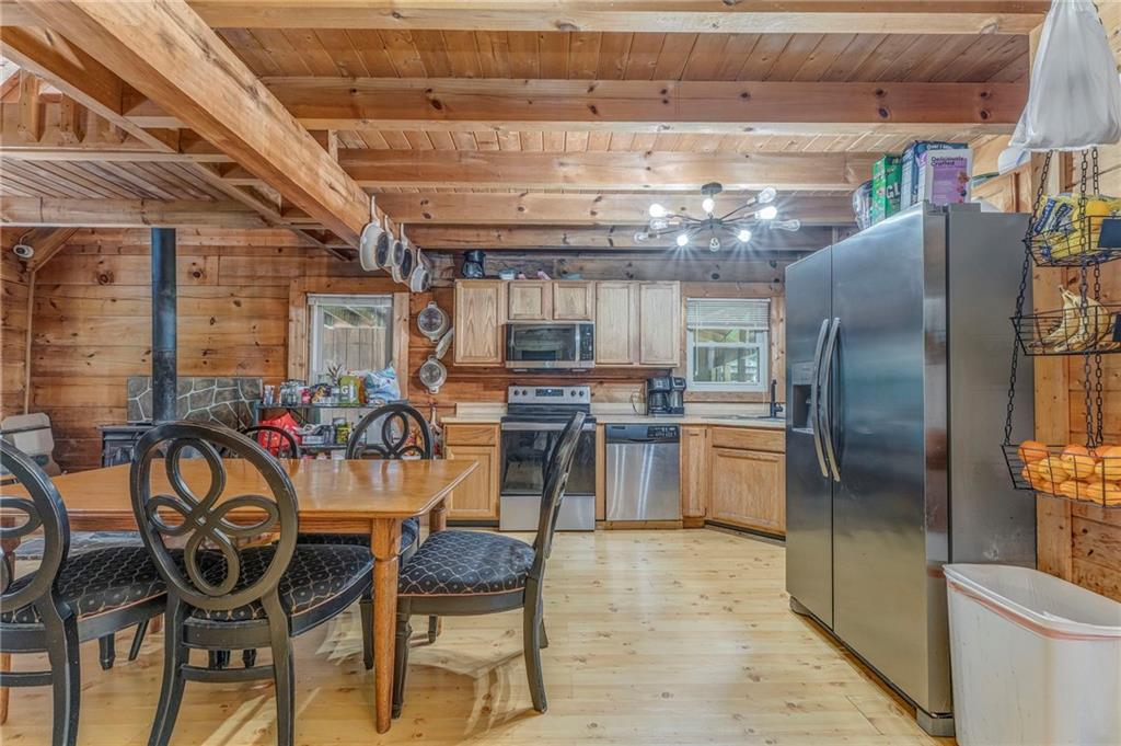 519 East Valley Road Northeast Rydal, GA 30171 - Photo 5 of 28 a kitchen with a refrigerator and a table chair