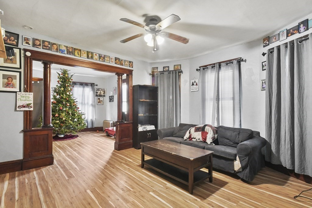 23 King Philip Road Worcester, MA 01606 - Photo 8 of 42 a living room with furniture and a chandelier