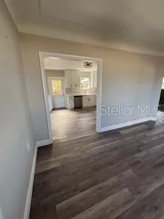 a view of a hallway with wooden floor and a fireplace