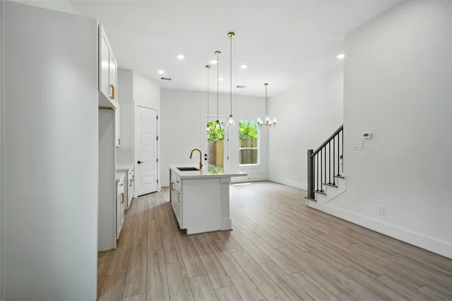 a view of kitchen with furniture and wooden floor