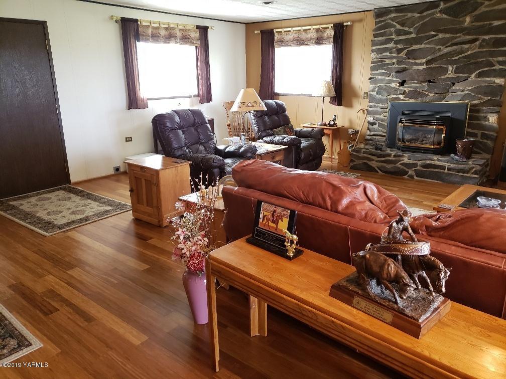 6235 Lateral A Road Wapato, WA 98951 - Photo 17 of 30 a living room with furniture hard wood floor and a fireplace
