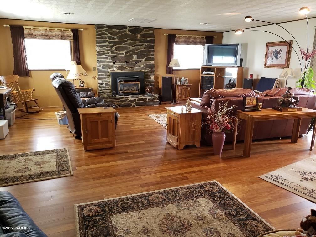 6235 Lateral A Road Wapato, WA 98951 - Photo 18 of 30 a living room with fireplace furniture and a rug