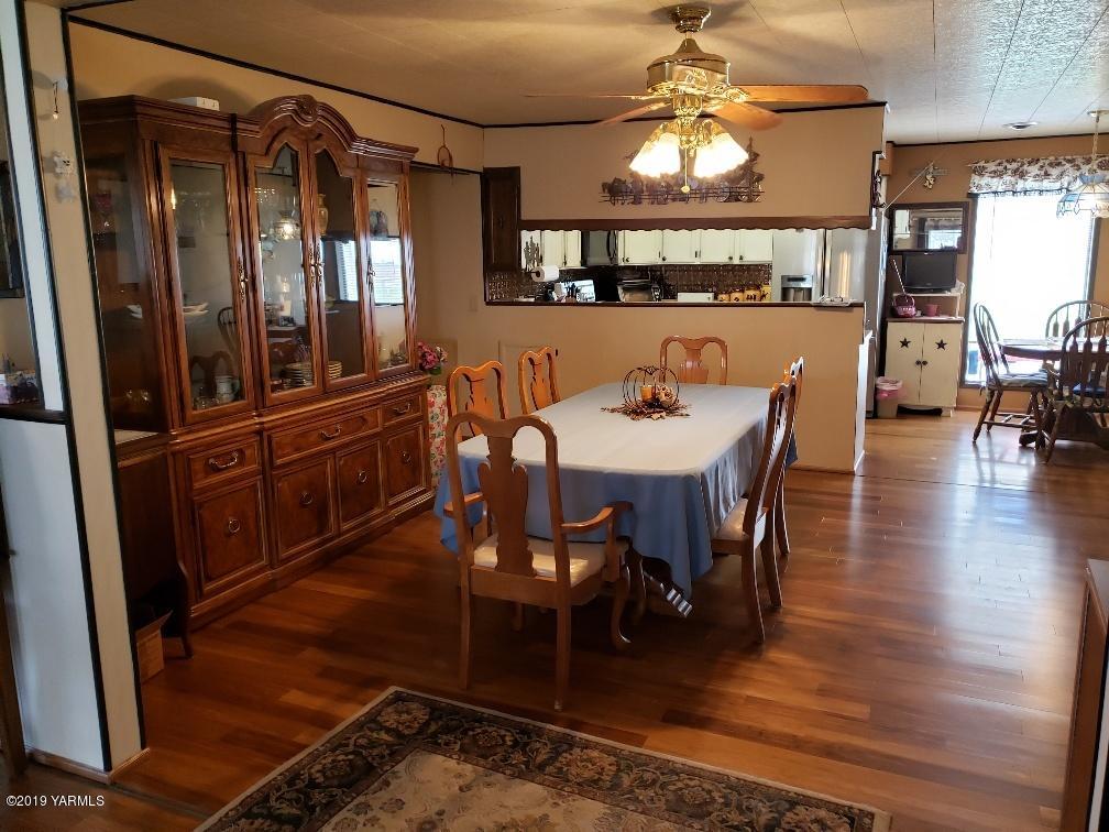 6235 Lateral A Road Wapato, WA 98951 - Photo 19 of 30 a view of a a dining room with furniture window and wooden floor