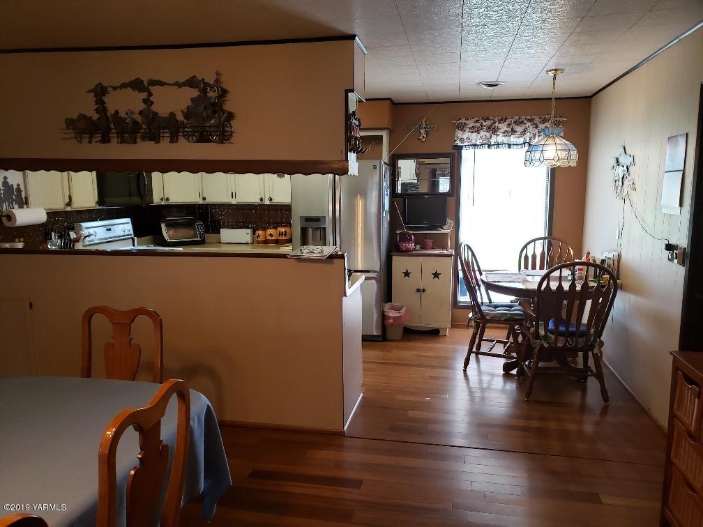 6235 Lateral A Road Wapato, WA 98951 - Photo 20 of 30 a view of a dining room with furniture and wooden floor