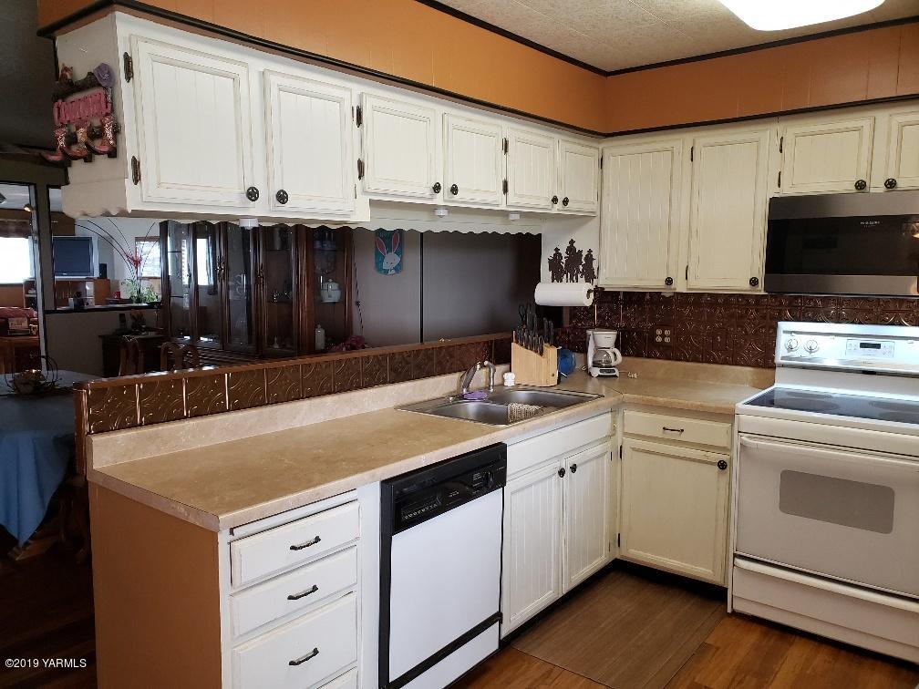6235 Lateral A Road Wapato, WA 98951 - Photo 22 of 30 a kitchen with granite countertop a sink and cabinets