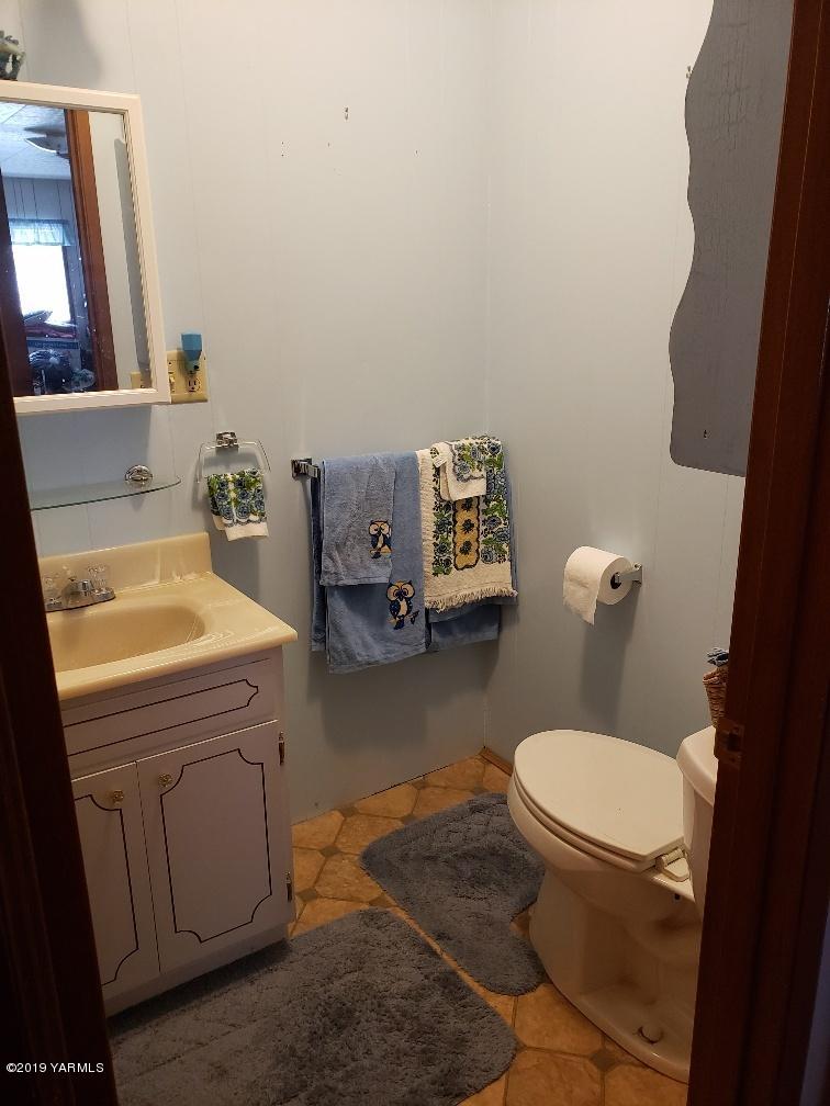 6235 Lateral A Road Wapato, WA 98951 - Photo 30 of 30 a bathroom with a toilet a sink and a mirror