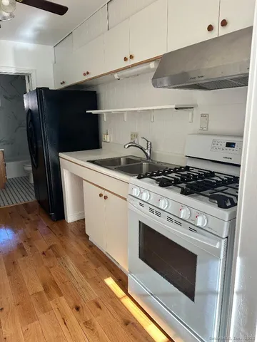 a kitchen with a stove and a refrigerator